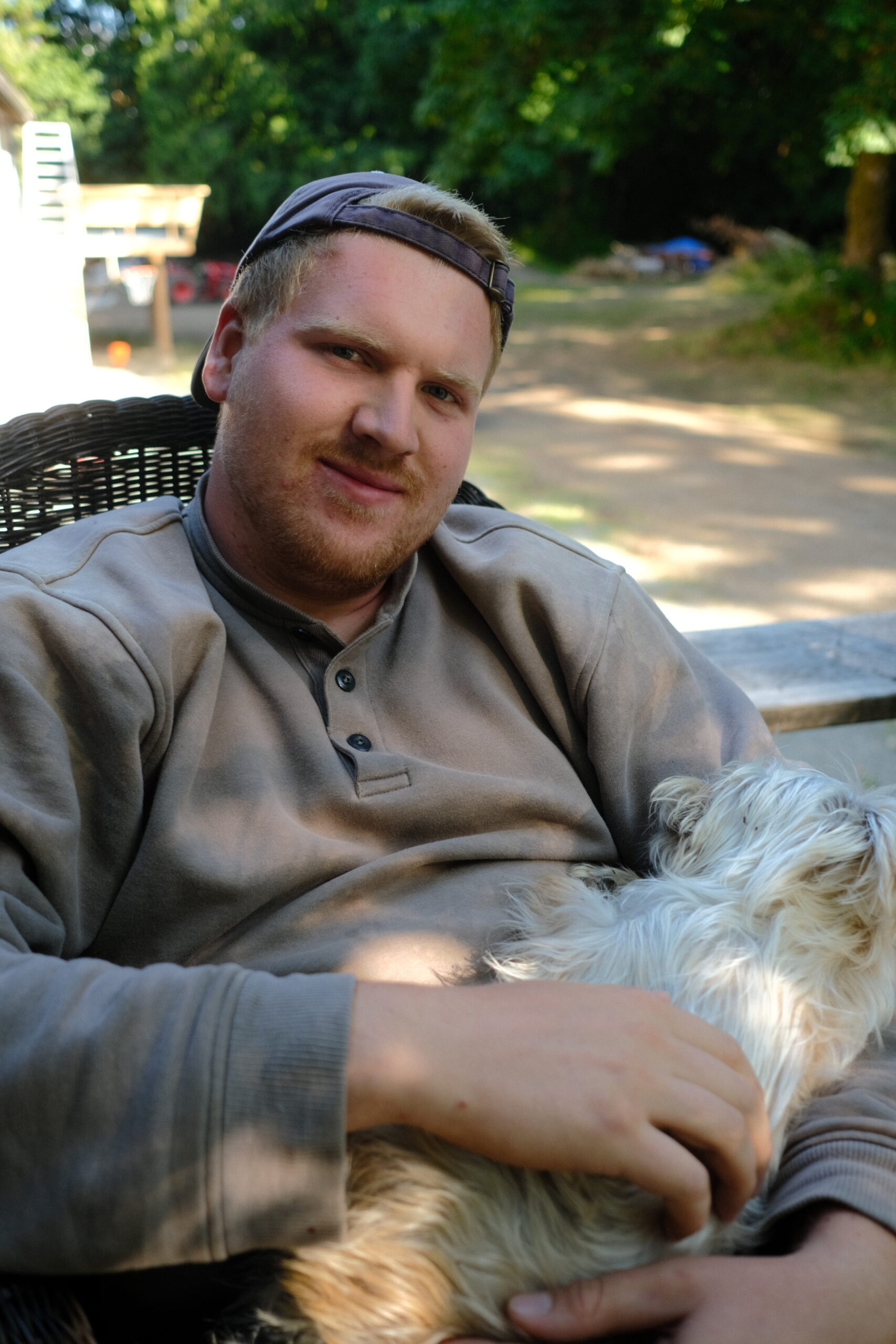 Young guy cuddling with puppy