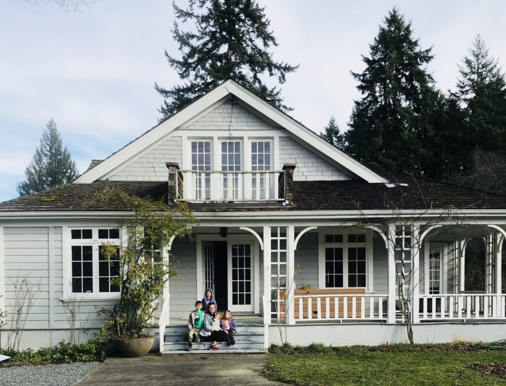 Front view white house with family on staircase