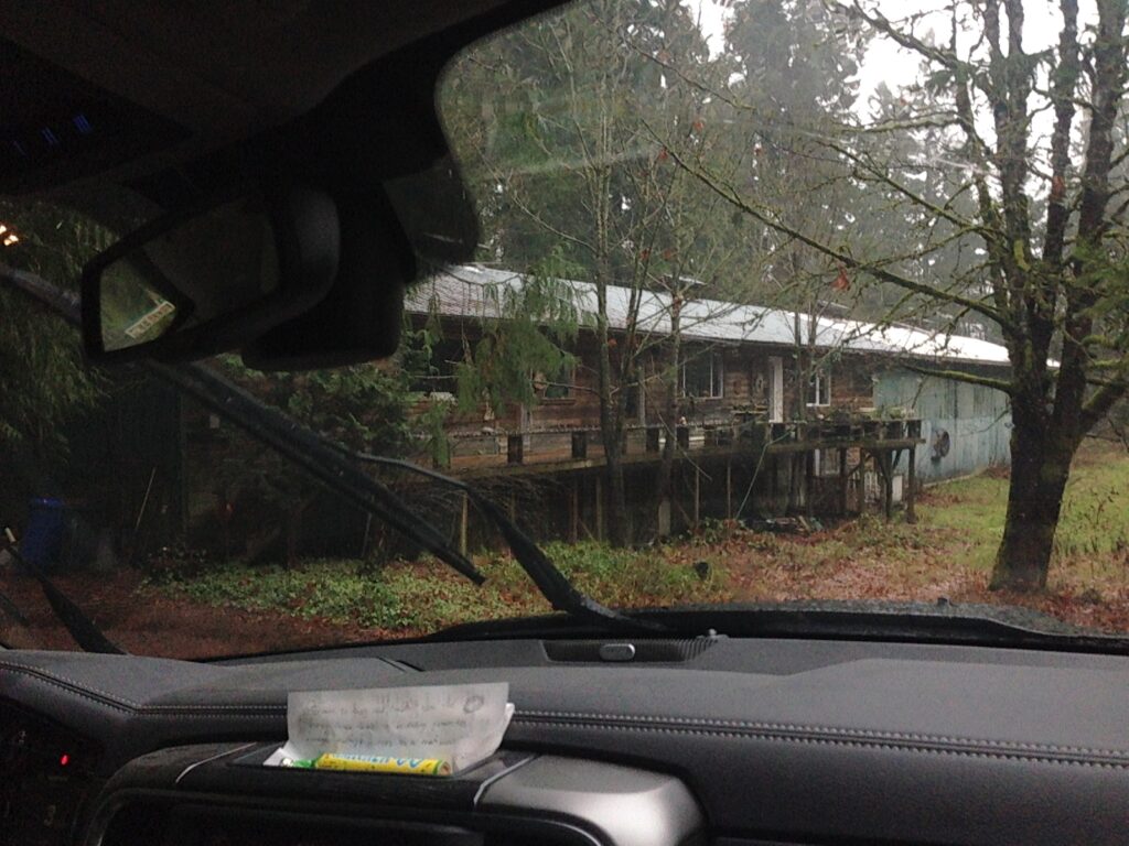 Foto of old barn in forest through windshield